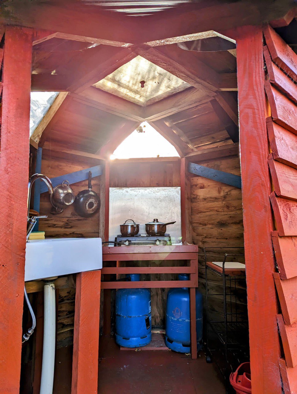 Covered outdoor kitchen at Rubha Phoil permaculture project on the Isle of Skye, with gas hob, drinking water, hot water, and all basic cooking essentials