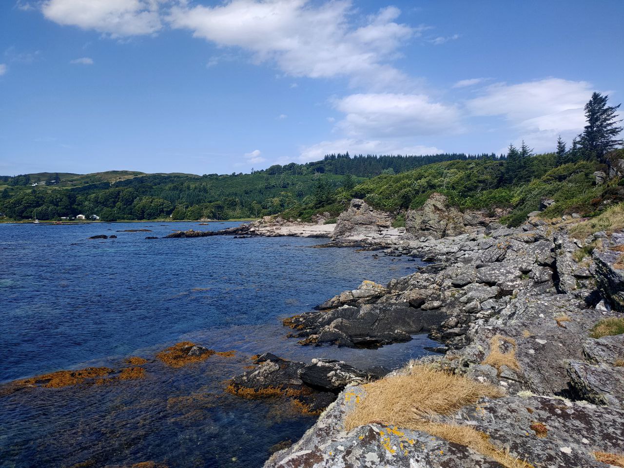 Rugged coastline and stone beaches at Rubha Phoil permaculture project on the Isle of Skye, with private bays for relaxing and enjoying a seaside bonfire